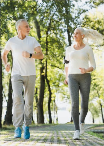 Mature couple going for a jog in the park.